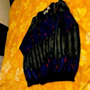 Men larger sweater in good condition. Color is black, purple and gray